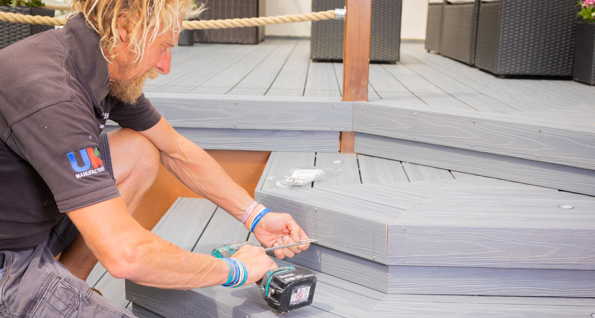 Builder installing Alchemy composite decking