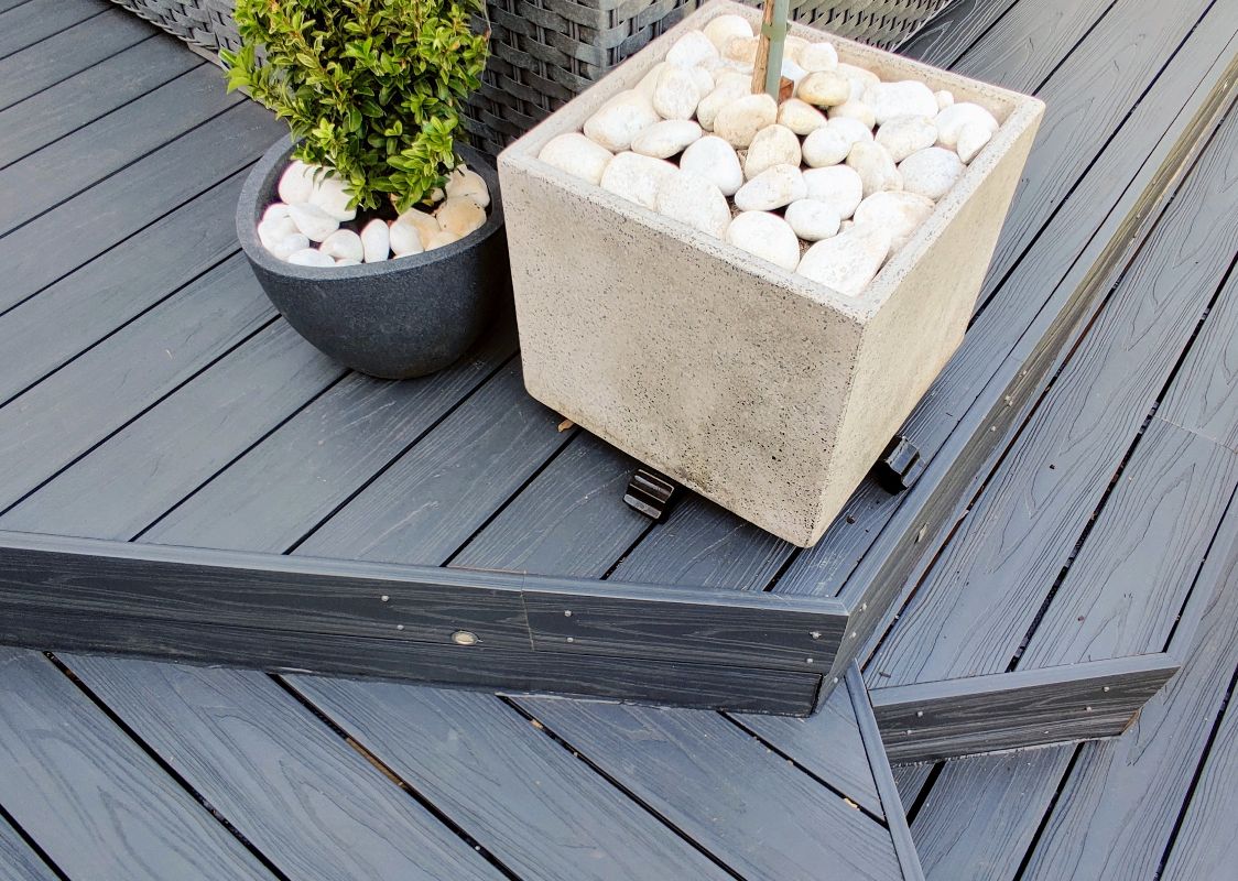 Close up of Alchemy Urban decking with two potted plants as accessories